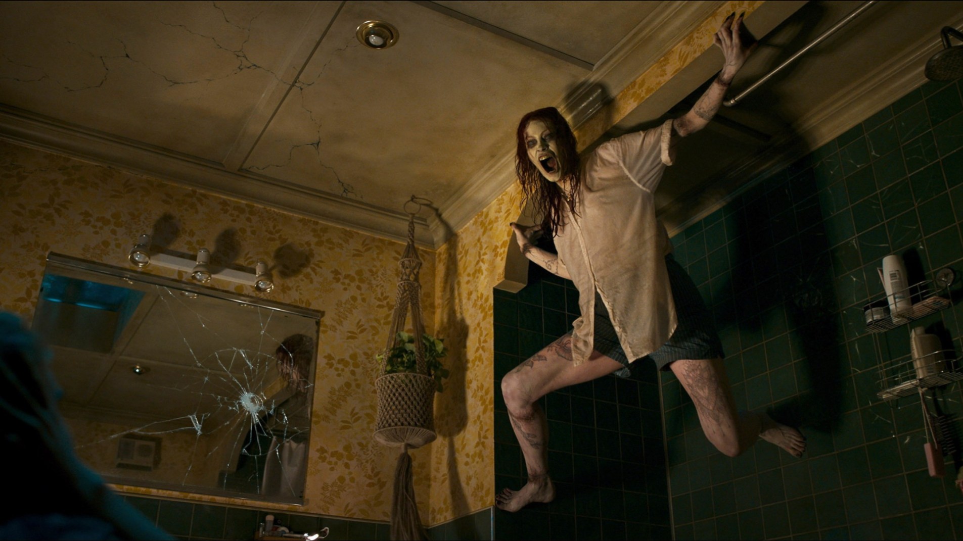 the villain of the new evil dead movie, a deadite on the ceiling